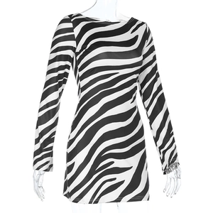 Detail of zebra print mini dress featuring a crew neck and tight long sleeve fit