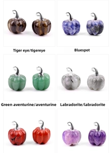 Macro shot of 20mm pumpkin crystal pendants with silver hooks in various natural stones