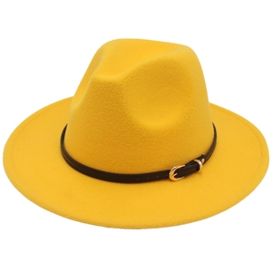 Close-up of a bright yellow fedora hat featuring a black leather band and gold buckle detail