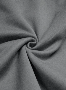 Detailed macro view of dark grey knitted fabric showing soft texture and premium material