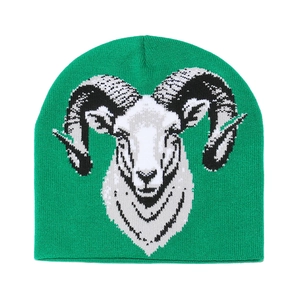 Close-up of green knit beanie featuring a detailed white ram head jacquard pattern