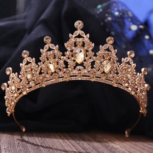 Close-up of golden bridal tiara featuring shimmering pear-cut crystals and leaf motifs