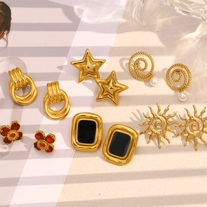 Close-up of vintage 18K gold plated earrings collection with pearls and floral motifs