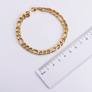 Golden 7mm Figaro chain bracelet measured with a ruler showing 21cm length