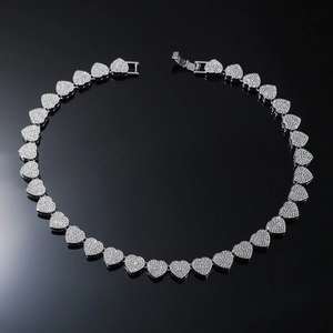 Macro shot of silver heart-shaped Cuban link necklace with sparkling pavé cubic zirconia