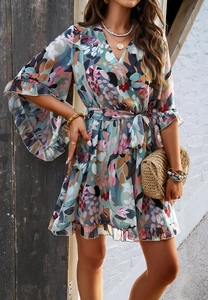 Detail of floral chiffon mini dress with V-neckline, ruffled sleeves and waist tie design