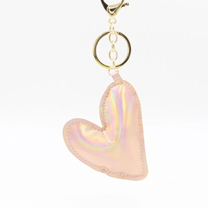 Pink holographic heart keychain with golden metal ring on a clean white background