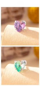 Macro display of heart-cut zircon stud earrings in gradient colors with silver metal claws