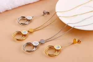 Detailed view of luxury gold and silver layered jewelry set with crystal encrusted rings