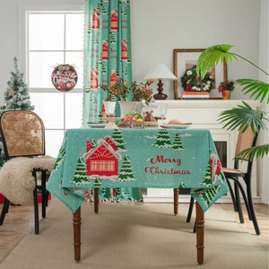Green Christmas tablecloth with red house and tree patterns and Merry Christmas text