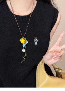 Detail of colorful acrylic star pendant necklace with long cord on a model