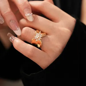 18K gold plated flower ring with marquise zircon stones worn by a model in a close-up