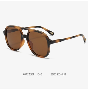 Detail view of tortoiseshell double-bridge pilot sunglasses with amber lenses, size 55-20-140