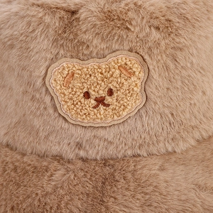 Detail of plush bucket hat featuring high-quality faux fur texture and cute bear embroidery