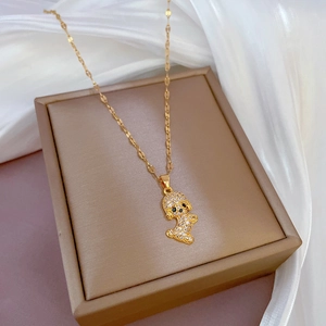 Gold puppy pendant necklace with micro-paved diamonds on a lip chain in a gift box
