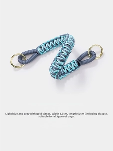 Detail of blue and grey woven bag strap with gold clasps and size measurements
