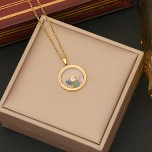 Detail of a gold locket necklace with Evil Eye and floating gems on a jewelry box