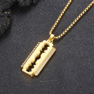 Close-up of hip hop gold razor blade pendant with CNC inlaid diamonds on box chain necklace