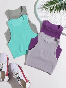 Close-up of ribbed knit athletic crop tops in grey, mint, and purple on a white background