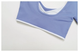Detail of light purple yoga top with U-neck design and white cross lining structure