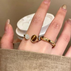 Detail of tiger eye stone ring set with gold plating and vintage maillard style texture
