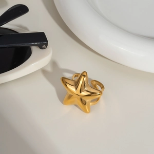 Detail view of a gold adjustable starfish ring featuring a polished metallic surface