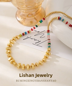 Detail of bohemian colorful stone bead necklace with 18k gold plated metal spacer beads