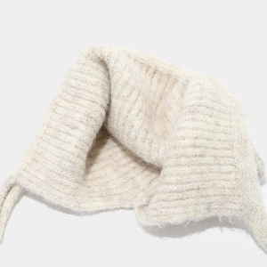 Detail of off-white chunky knit beanie with earflaps and soft ribbed texture strings