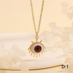 Detailed view of evil eye pendant necklace in 18K gold plating on a white display plate