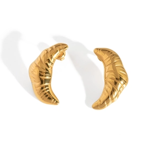 Detailed macro shot of golden textured croissant-shaped stainless steel stud earrings