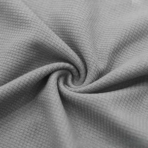 Macro shot of gray waffle knit fabric texture showing breathable 3D grid weave detail