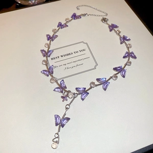 Detail of purple crystal butterfly choker necklace with silver-tone chain links