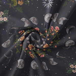 Detailed macro shot of bohemian tapestry fabric with moon phases and floral patterns