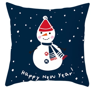 Detail of blue winter pillow cover featuring a snowman pattern and Happy New Year text