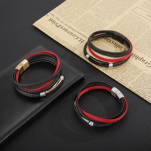 Close-up of multi-layer woven leather bracelets with steel magnetic clasps on a wallet