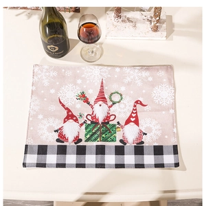 Christmas gnome placemat with snowflakes and gifts on a beige linen texture table mat