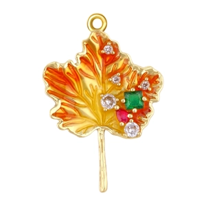 Close-up of maple leaf pendant with orange enamel and inlaid green square gemstones