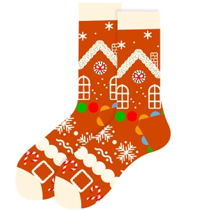 Détail de chaussettes de Noël orange avec motif de maison en pain d'épices et de bonbons