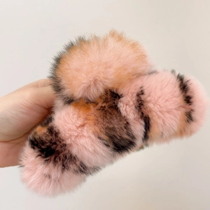 Detail of extra large plush claw clip with pink orange tiger stripe faux rabbit fur