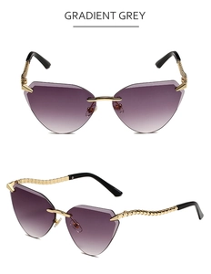 Detailed view of rimless cat-eye sunglasses with gradient grey lenses and gold metal arms