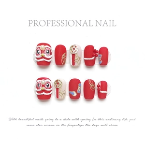 Handmade 3D Lion Dance nail tips in festive red and white with pearl accents