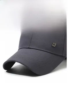Detail of dark grey baseball cap featuring structured brim and metal logo accent