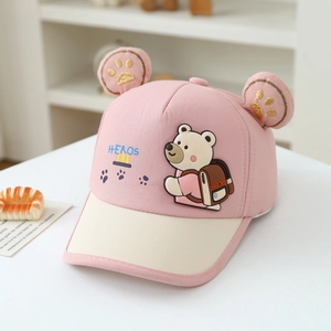 Close-up of pink baby baseball cap with 3D ears, bear print and gold embroidery detail