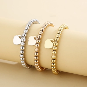 Three-piece stainless steel beaded bracelet set in gold, silver, and rose gold with heart charms