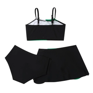 Three-piece black bikini set with neon green trim including top, bottoms, and skirt