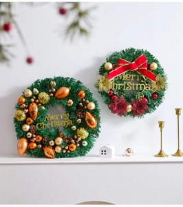 Close-up of pine needle Christmas wreath with red ornaments and Merry Christmas sign