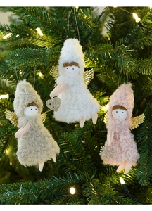 Three plush Christmas angel ornaments with sequin wings hanging on a festive tree