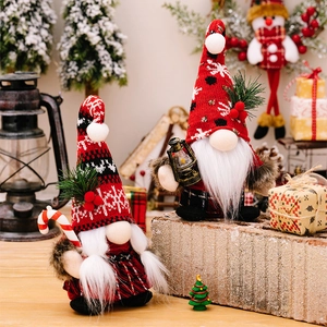 Detail of Christmas gnomes with knit snowflake hats, candy cane and lantern in festive decor