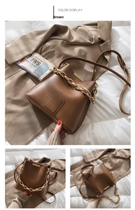 Detailed view of brown bucket bag with chunky gold chain strap and leather shoulder strap