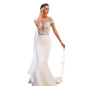 Elegant white mermaid wedding dress with deep V-neck and delicate floral lace detailing